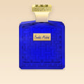 HOUBIGANT Santal Mistral Eau de Parfum Extrême 100ml — flacon bleu cobalt sur fond éditorial Côte d'Azur au coucher du soleil, parfum boisé ambré