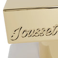 Jousset Parfums Donut Crave Frosted Vanilla — macro du bouchon doré gravé Jousset, finition polie miroir