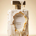 Jousset Parfums Donut Crave Frosted Vanilla Extrait de Parfum 50 ml — visuel de campagne, flacon nappé de glaçage blanc et pâte à donut dorée
